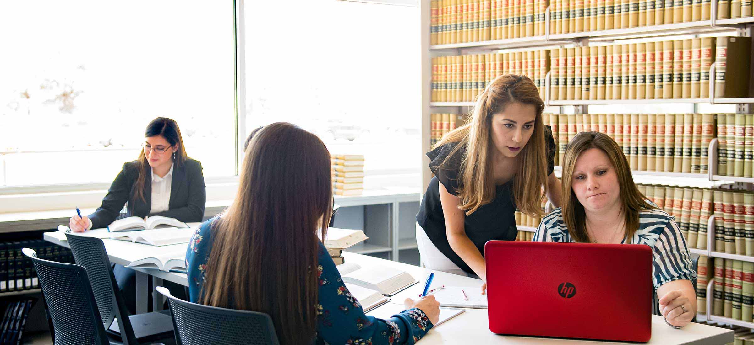 Paralegal students working in a library