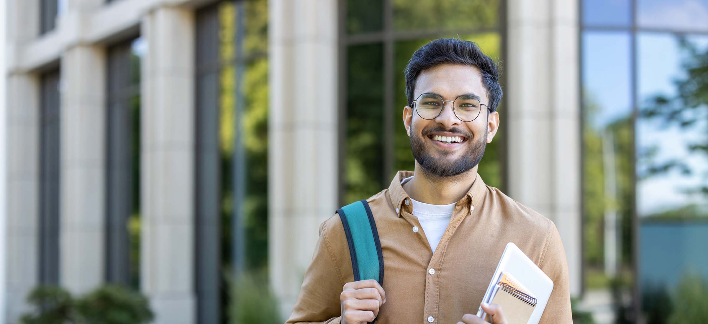 adult learner smiling at camera ready to return to school to complete his studies