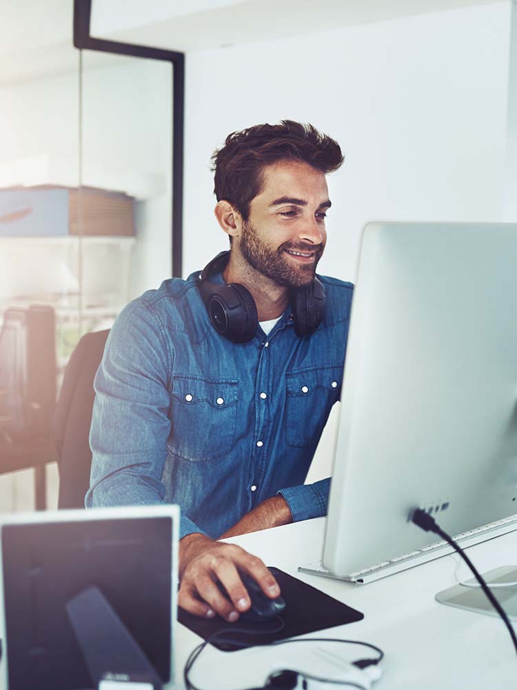 Businessman smiling while coding.