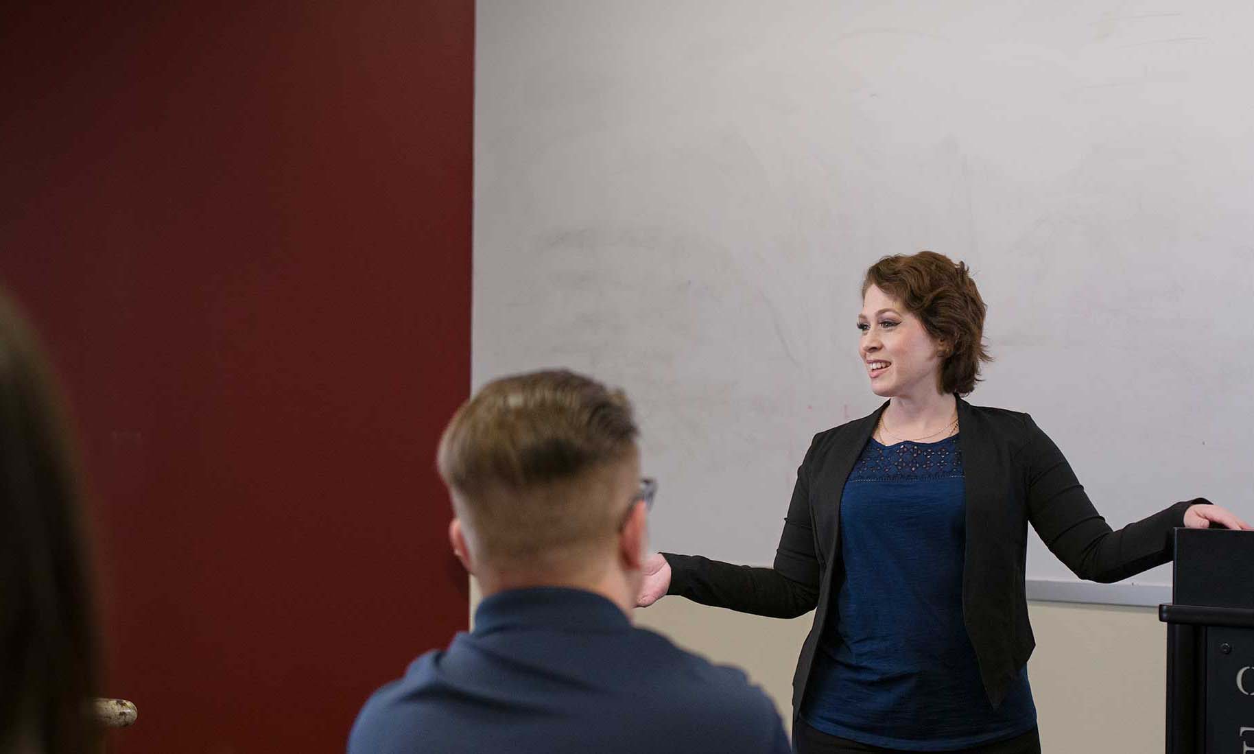 Employee standing in front of class. 