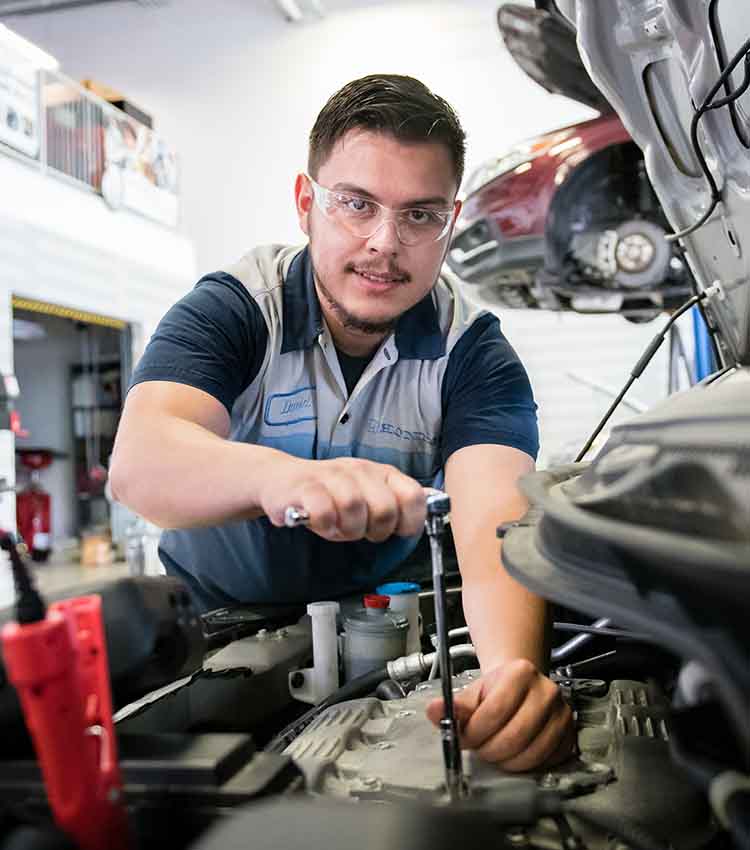 honda pact student working on the battery area of a car