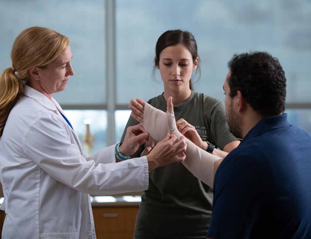 Physical Therapist Assistant helps patient
