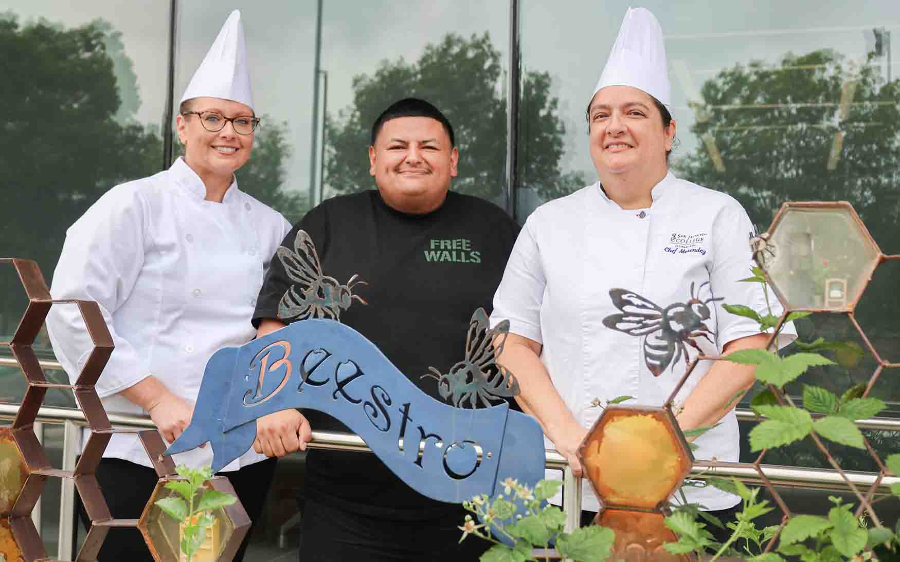 Culinary graduate Chef Adrian Torres (center) with San Jac culinary arts instructors Chefs Andrea Huerta (left) and Melissa Menendez (right).